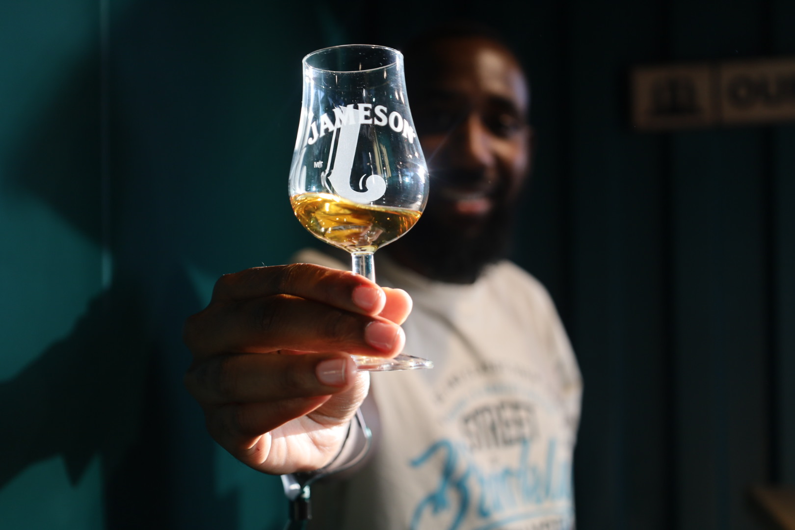 Thendo Muloiwa holding a Jameson whiskey tasting glass